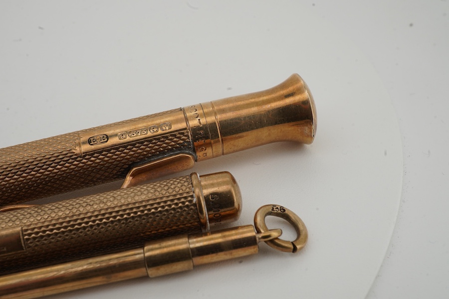 Two engine turned 9ct gold cased pencils including smallest by Sampson Mordan & Co, hallmarked for London, 1937, 7cm, the smaller with engraved inscription, together with a gold plated swizzle stick, larger pencil by E.